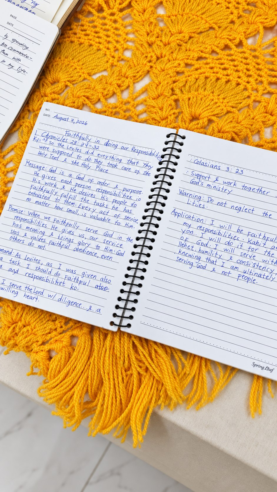 A handwritten AHMVAS devotional reflection in an open notebook